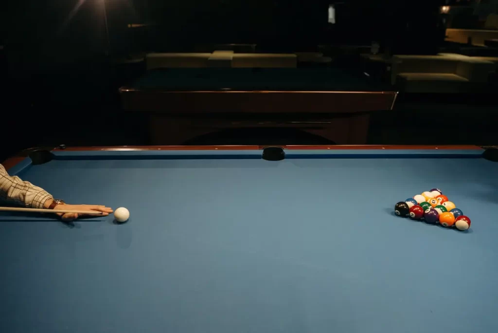 A person breaking a pool game.